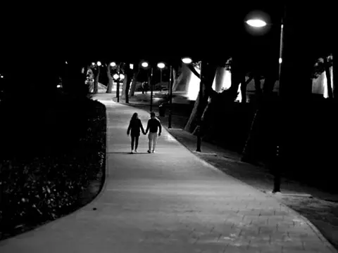 Couple Walking in the evening - Alma by Geraldine Connolly