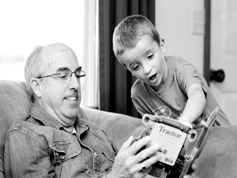 Grandfather and grandson with a book